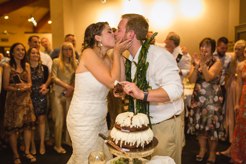 bride and groom embracing near dessert