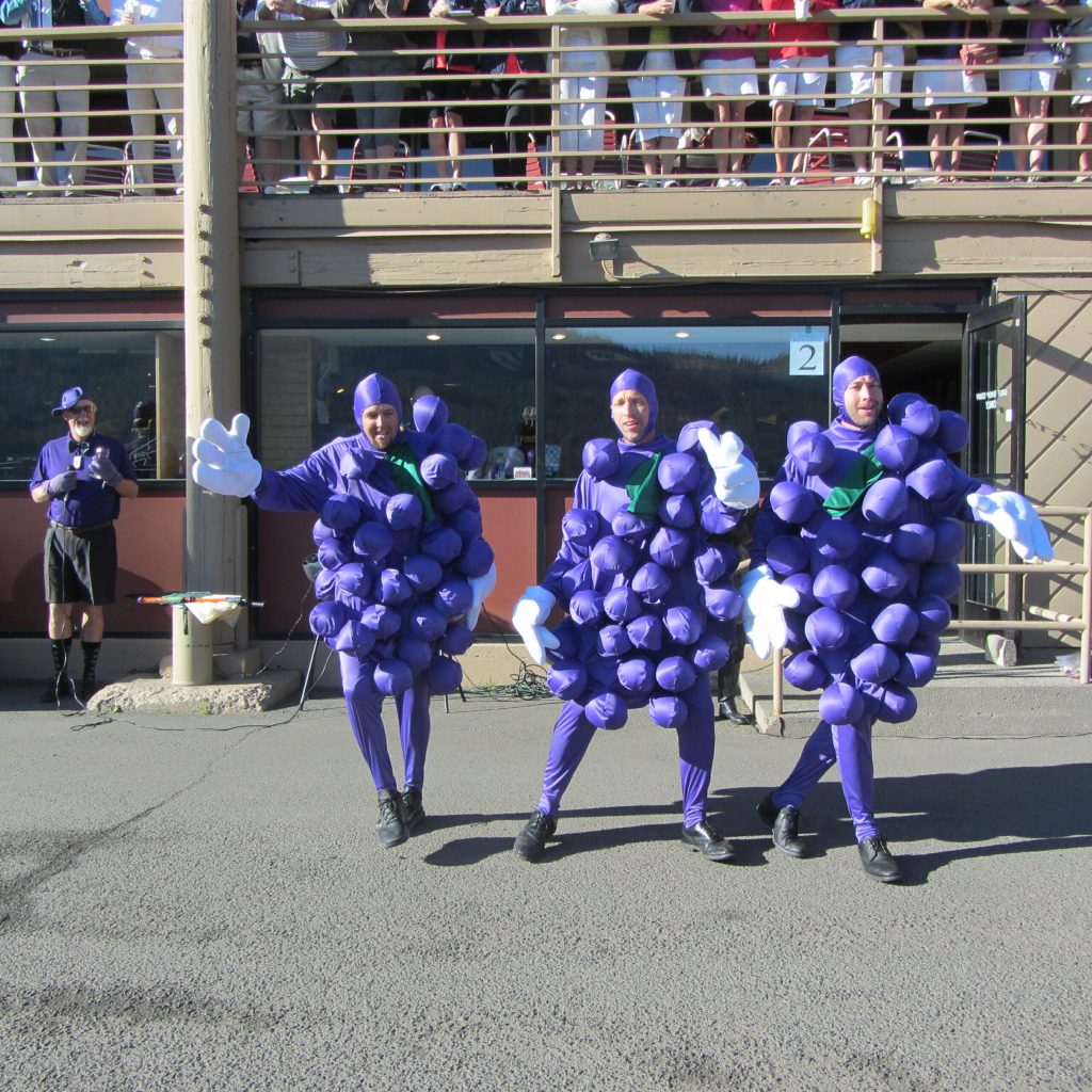men in grape costumes dancing