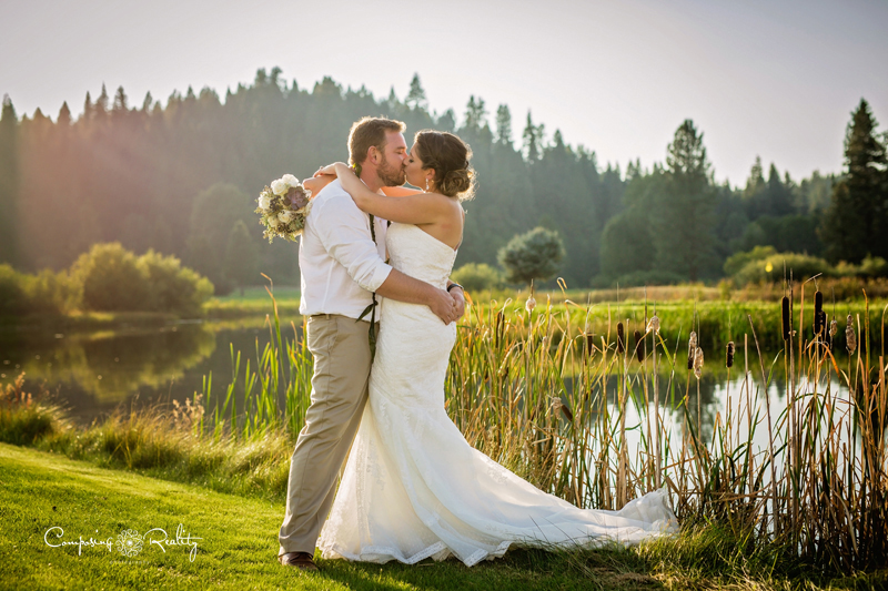 bride and groom embracing on golf course